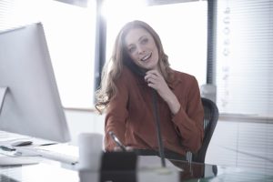 Woman at her desk on the telephone